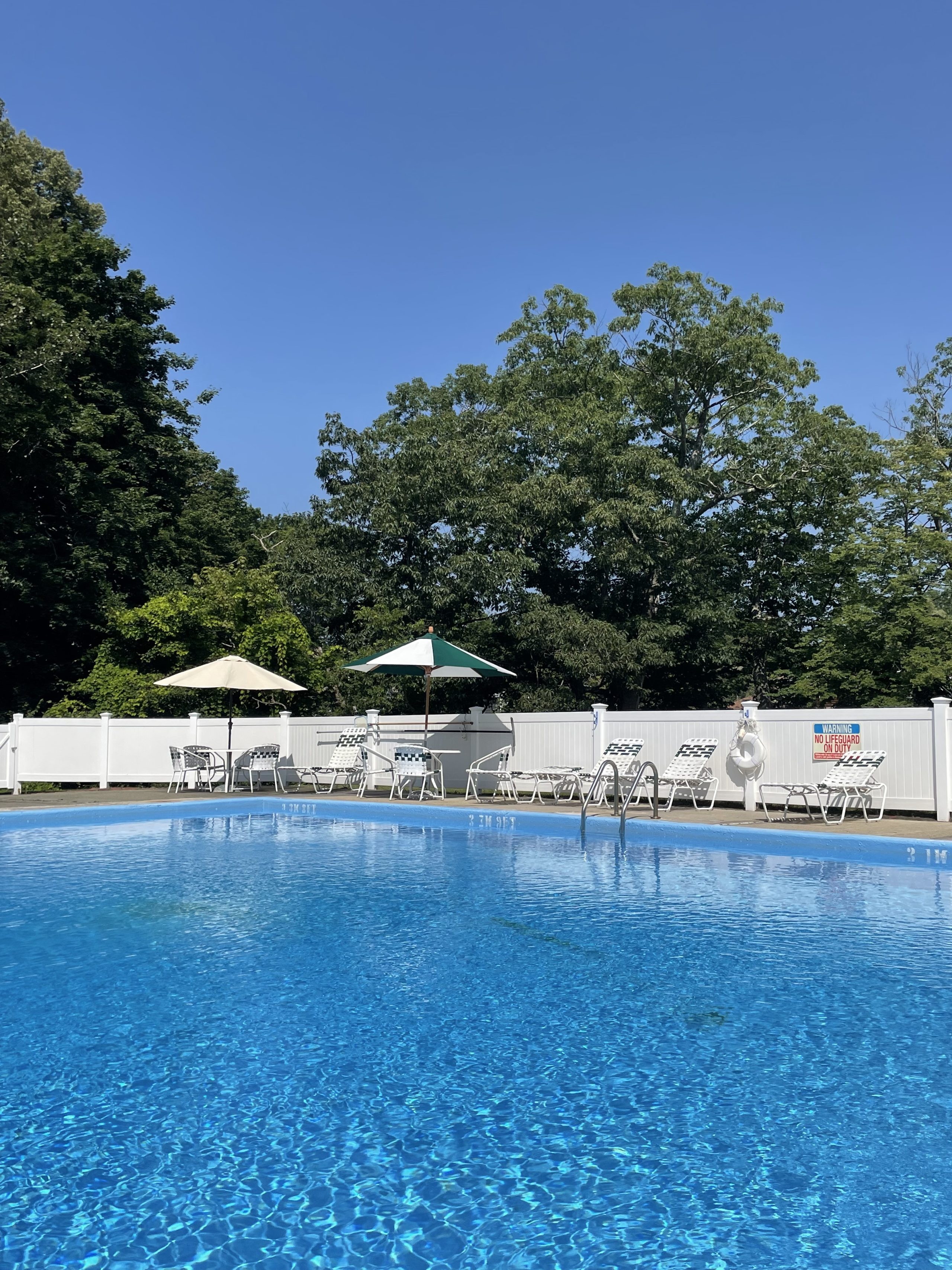 A bright blue outdoor swimming pool.