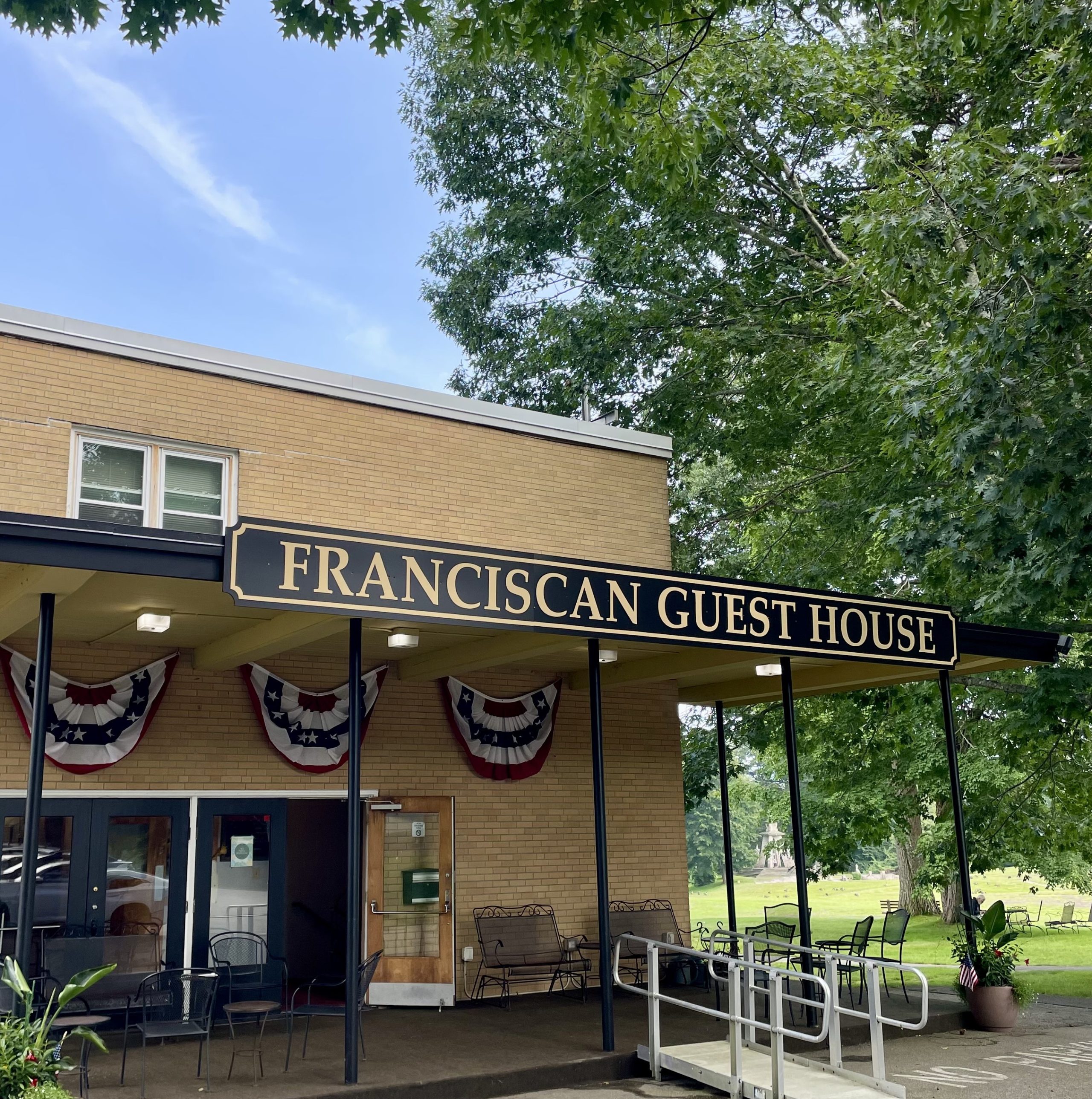 Building with a sign that reads "Franciscan Guest House".